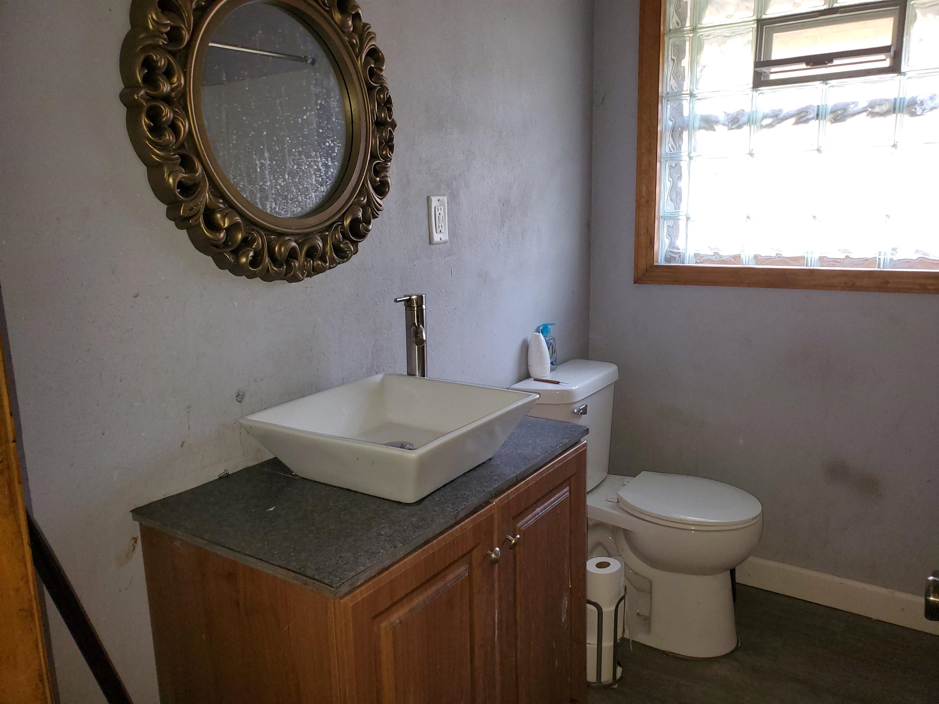 2511 Ashland Avenue Rockford, IL 61101 - Photo 14 of 15 a bathroom with a toilet a sink and a window