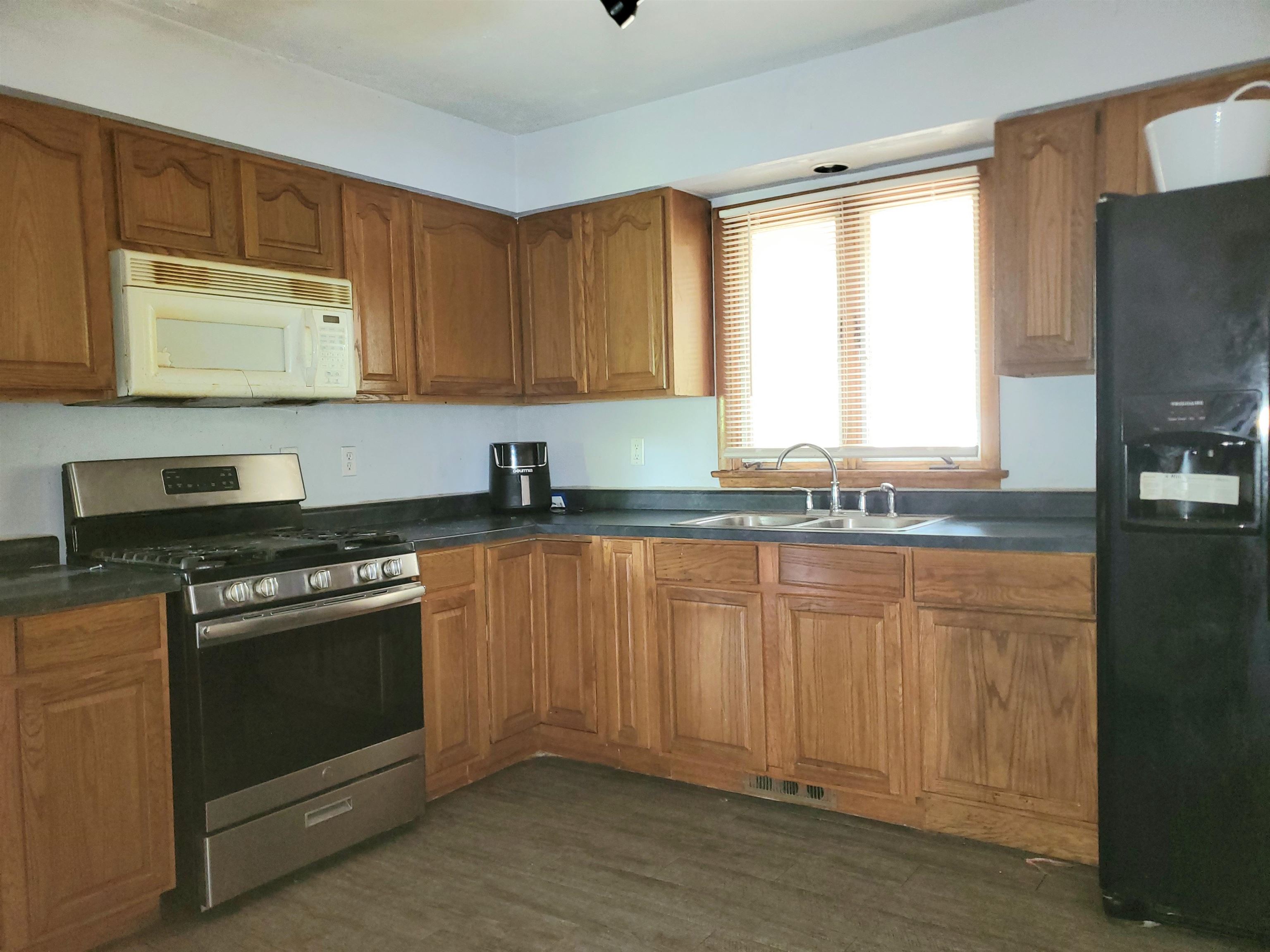 2511 Ashland Avenue Rockford, IL 61101 - Photo 6 of 15 a kitchen with stainless steel appliances granite countertop a stove a sink and a microwave
