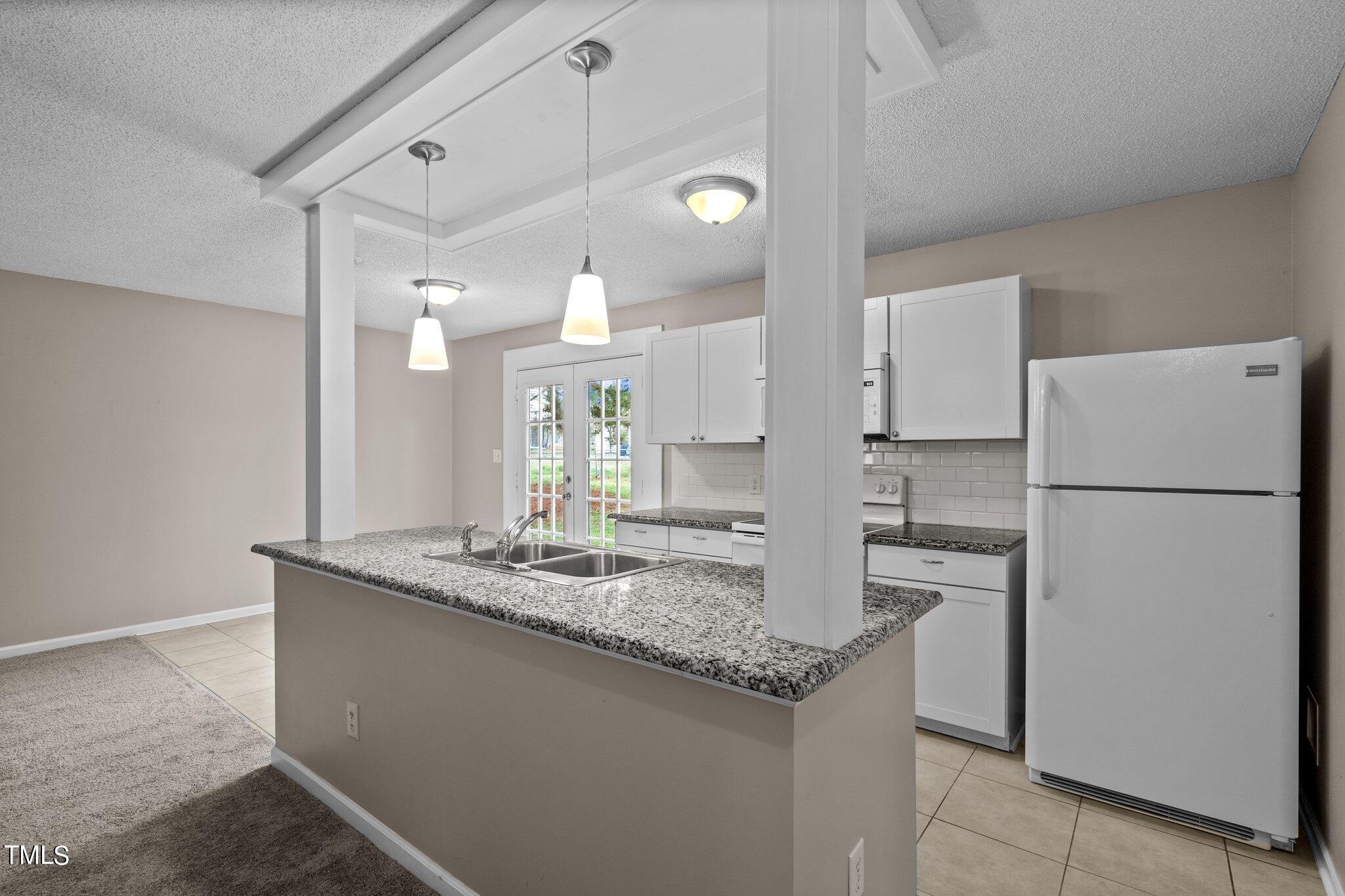 1129 Bermuda Run Knightdale, NC 27545 - Photo 13 of 34 a kitchen with refrigerator and countertop
