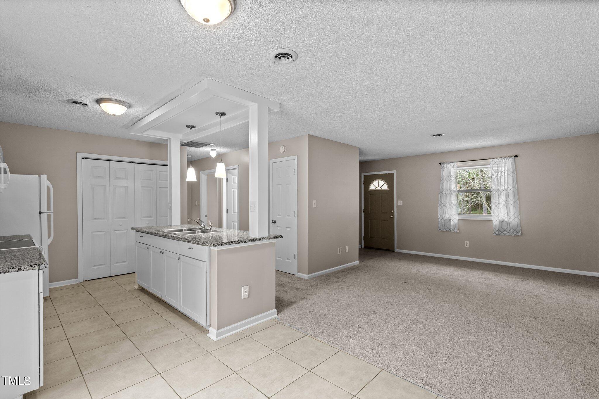 1129 Bermuda Run Knightdale, NC 27545 - Photo 14 of 34 a kitchen with stainless steel appliances granite countertop a stove and a refrigerator