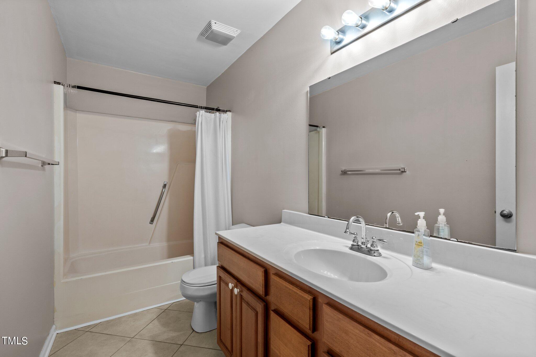 1129 Bermuda Run Knightdale, NC 27545 - Photo 16 of 34 a bathroom with a sink toilet tub and shower