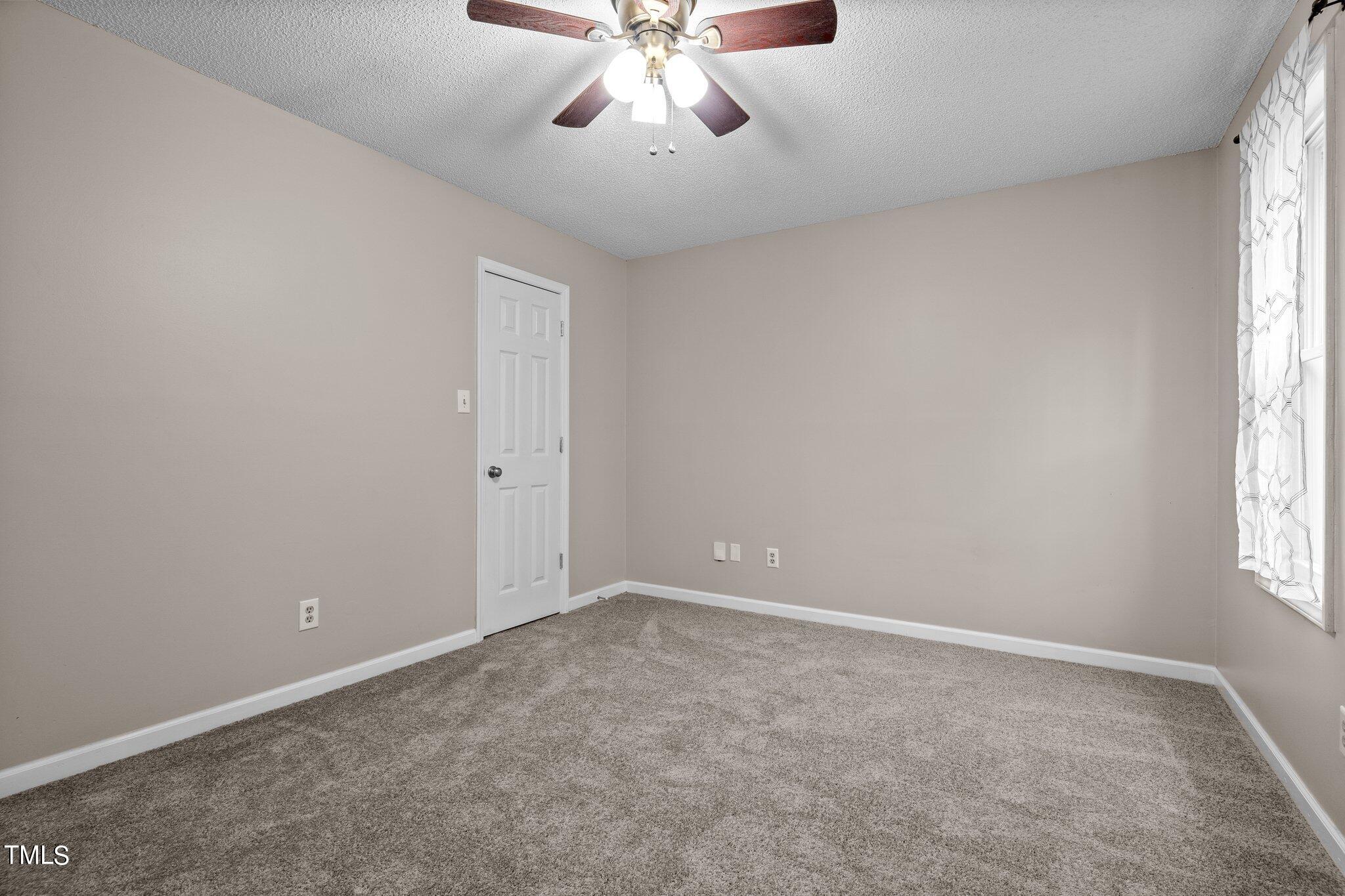 1129 Bermuda Run Knightdale, NC 27545 - Photo 18 of 34 an empty room with windows and fan
