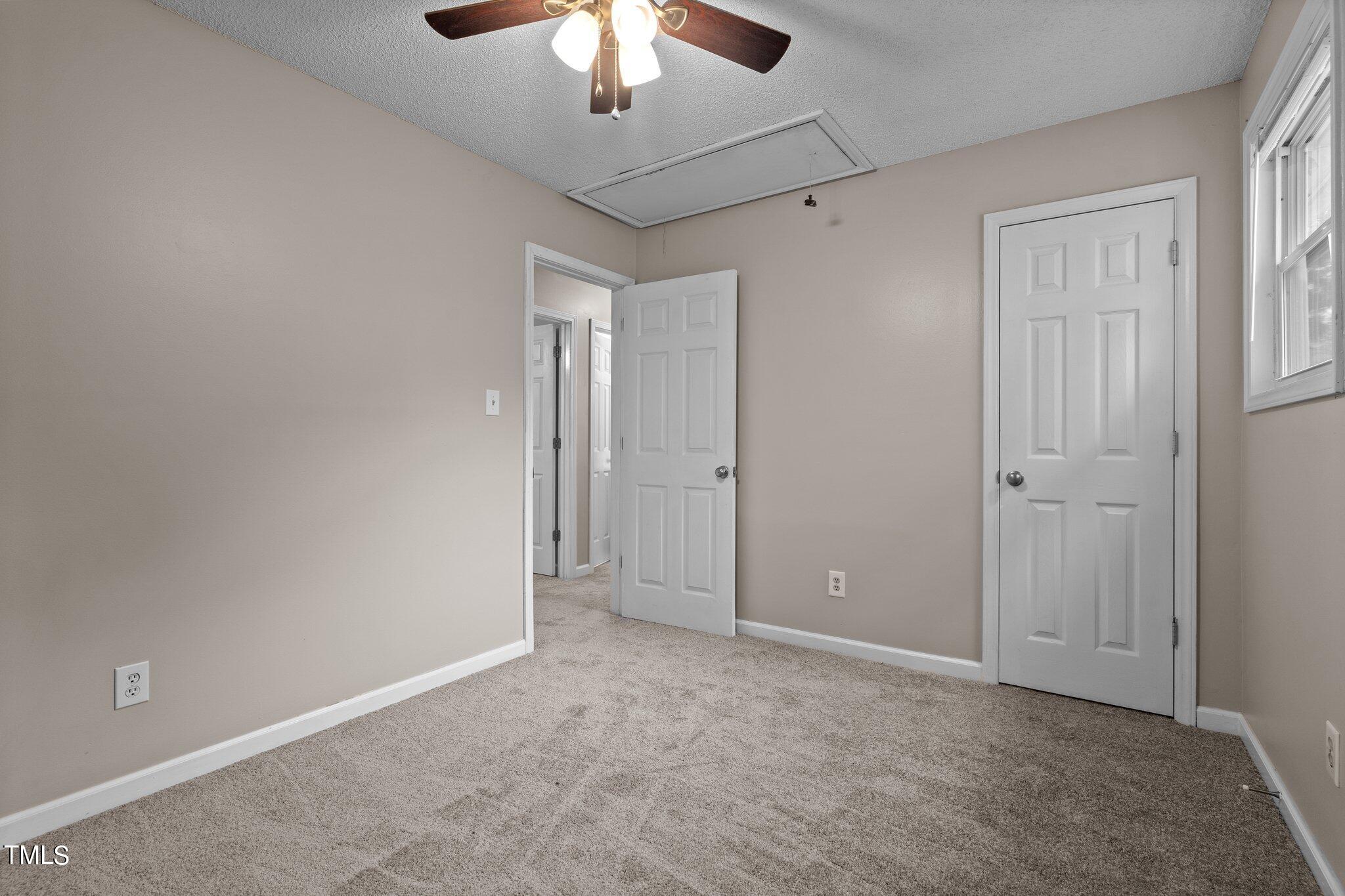 1129 Bermuda Run Knightdale, NC 27545 - Photo 23 of 34 an empty room with chandelier fan