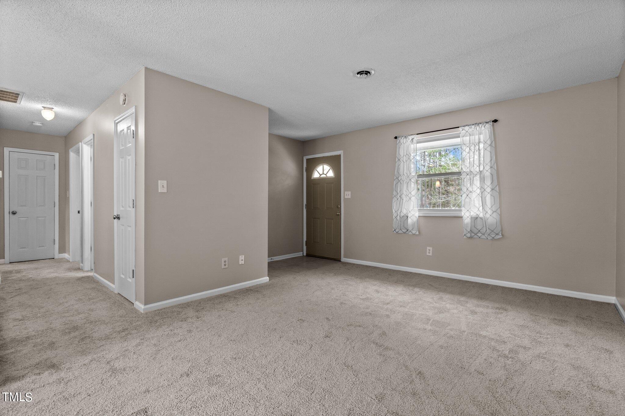 1129 Bermuda Run Knightdale, NC 27545 - Photo 7 of 34 a view of an empty room with a window