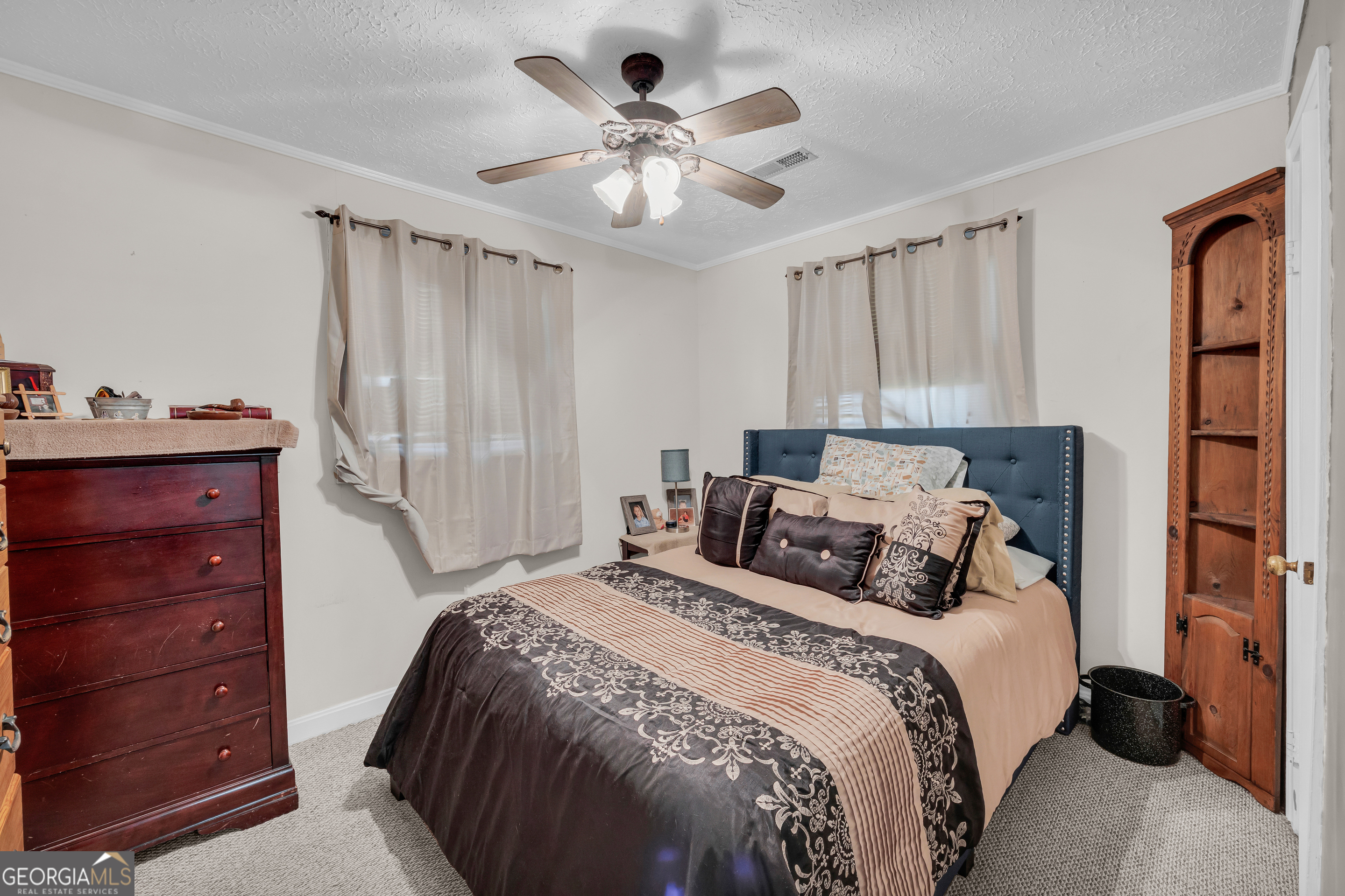 88 Maurice Way Lavonia, GA 30553 - Photo 16 of 65 a bedroom with a bed and a ceiling fan