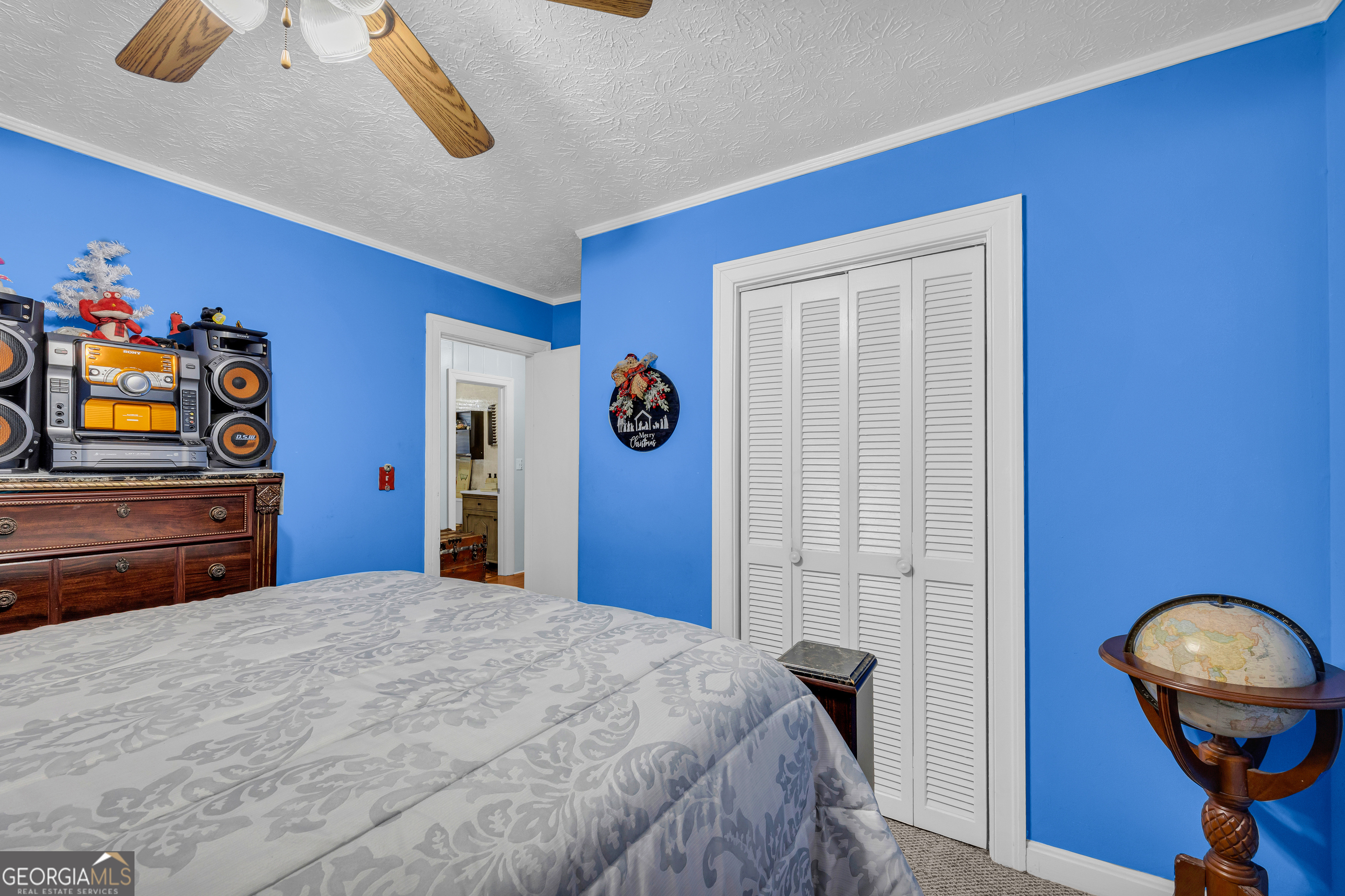 88 Maurice Way Lavonia, GA 30553 - Photo 19 of 65 a bedroom with a bed and a flat tv screen on dresser