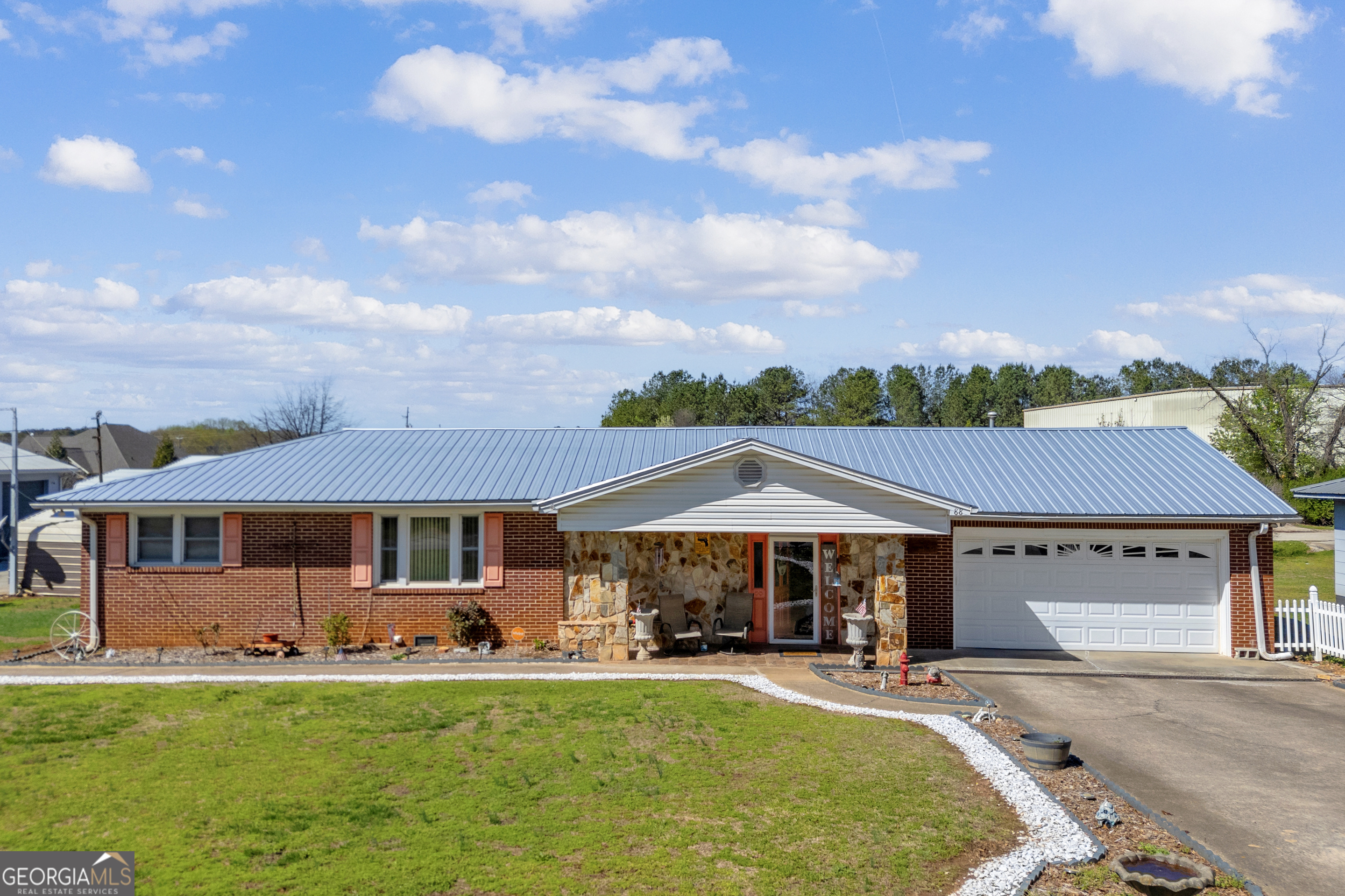 88 Maurice Way Lavonia, GA 30553 - Photo 2 of 65 a patio with a table and chairs under an umbrella