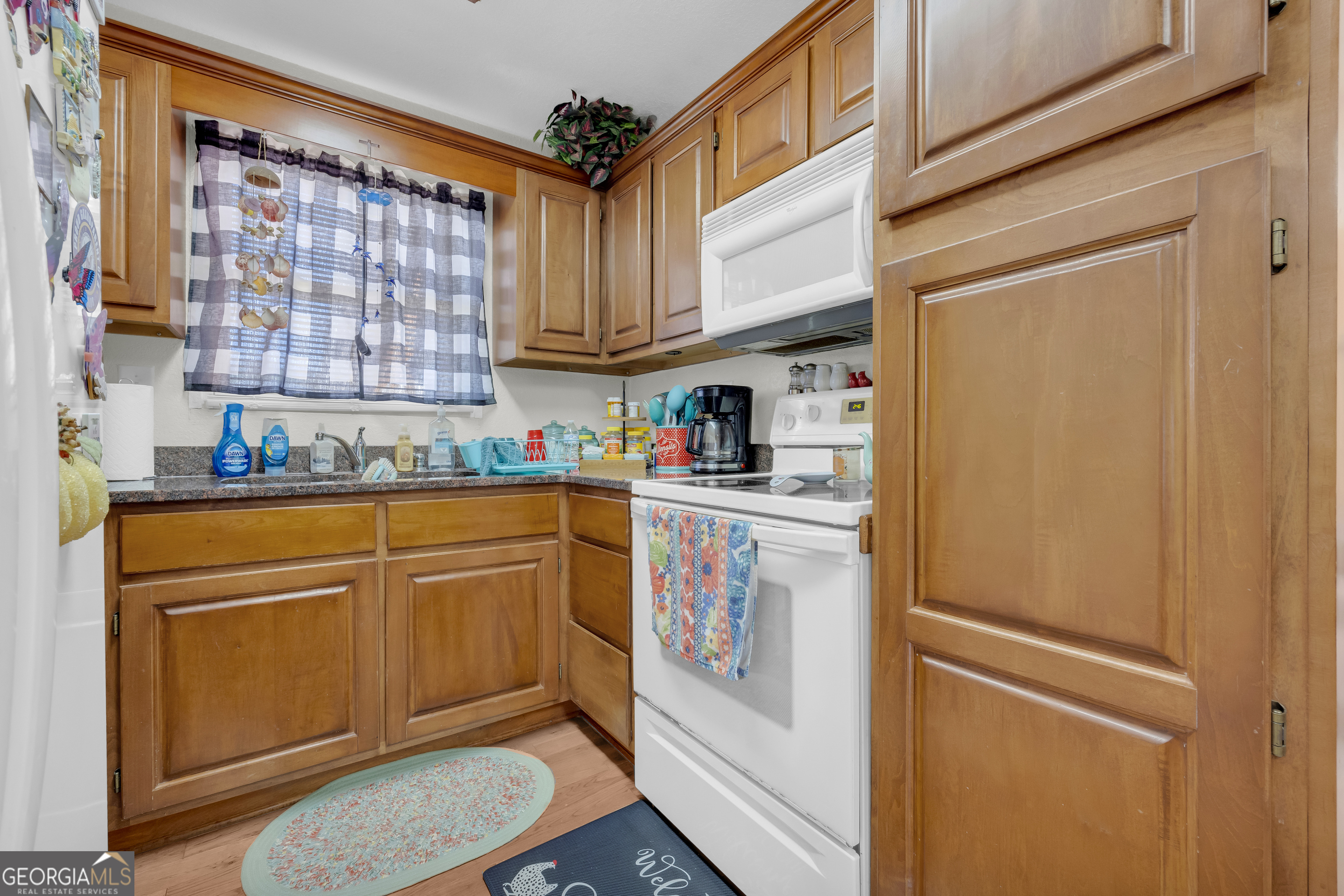 88 Maurice Way Lavonia, GA 30553 - Photo 22 of 65 a kitchen with stainless steel appliances granite countertop a refrigerator a sink dishwasher and cabinets with wooden floor