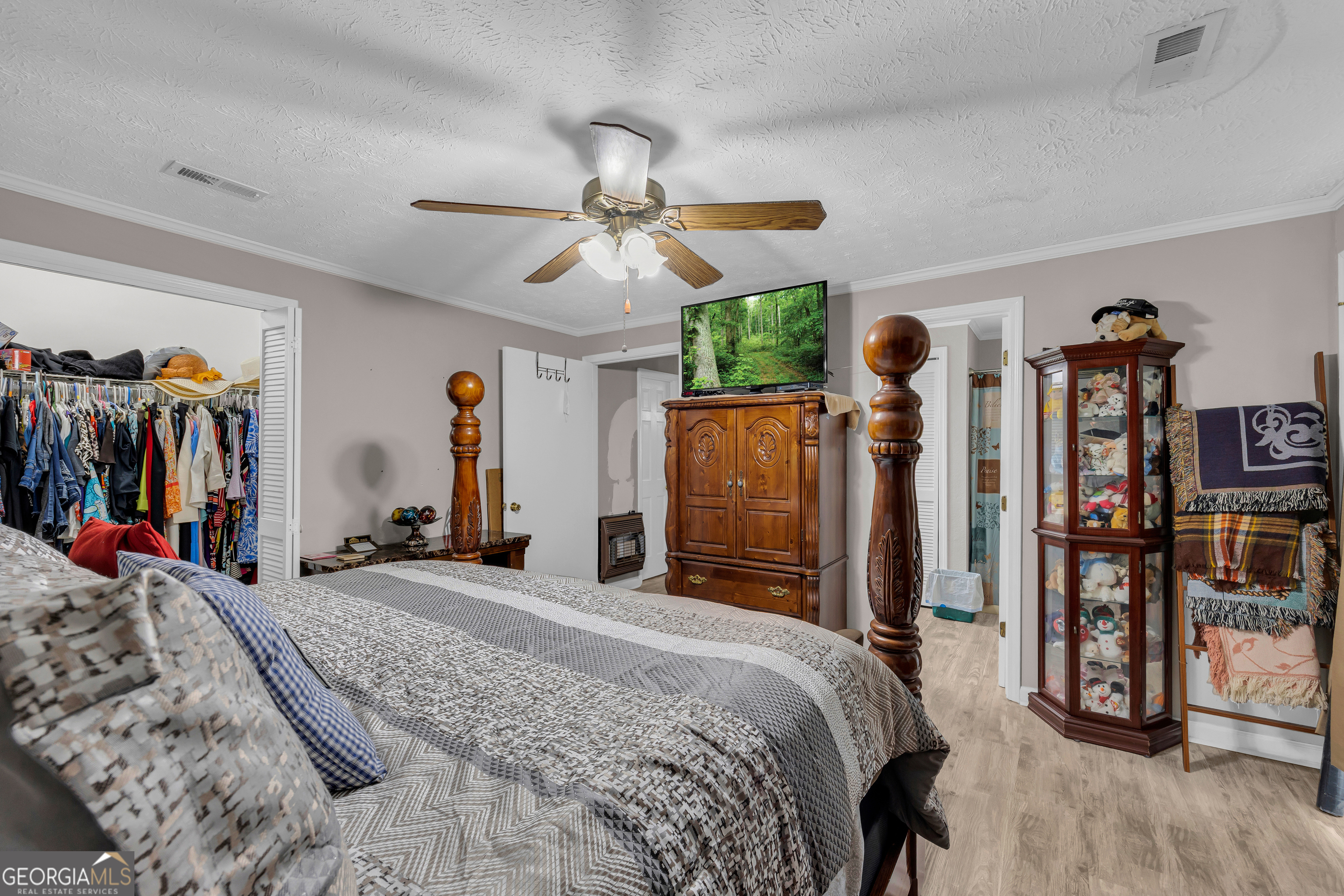 88 Maurice Way Lavonia, GA 30553 - Photo 27 of 65 a bed room with a bed and a walk in closet