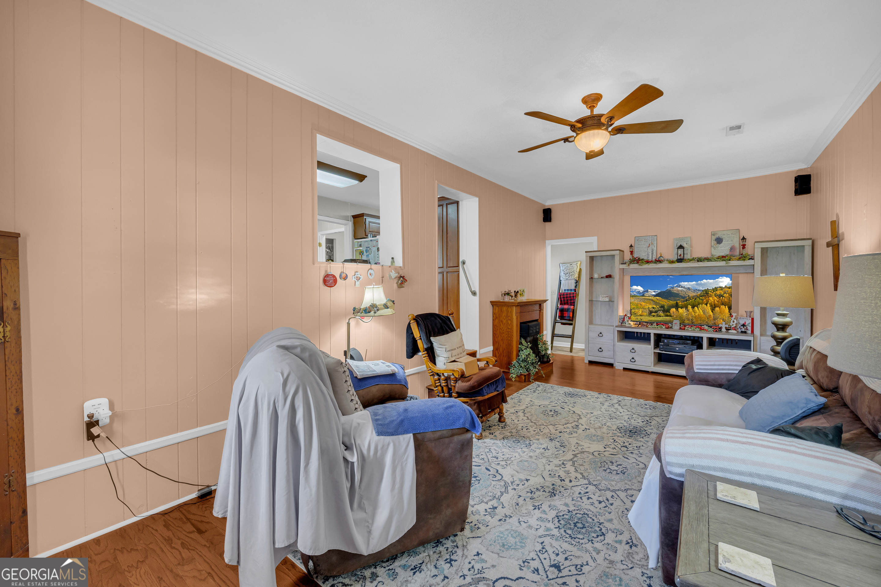 88 Maurice Way Lavonia, GA 30553 - Photo 5 of 65 a living room with furniture a flat screen tv and a ceiling fan