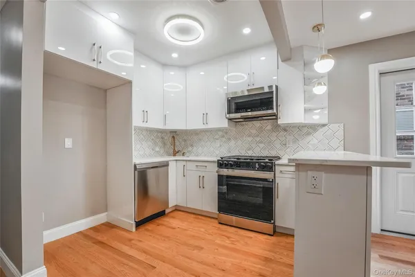 a kitchen with stainless steel appliances granite countertop a stove and a sink