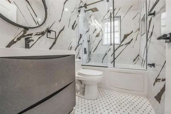 a bathroom with a toilet and a mirror