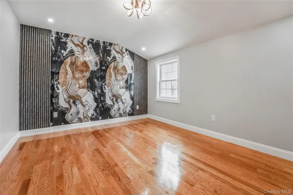 a view of a room with wooden floor and window