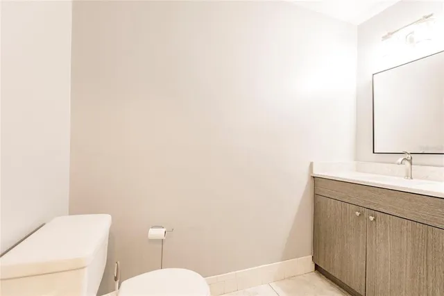 a white toilet next to a bathroom