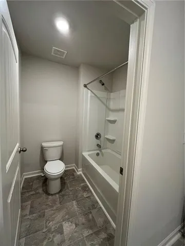 a bathroom with a toilet a sink and shower