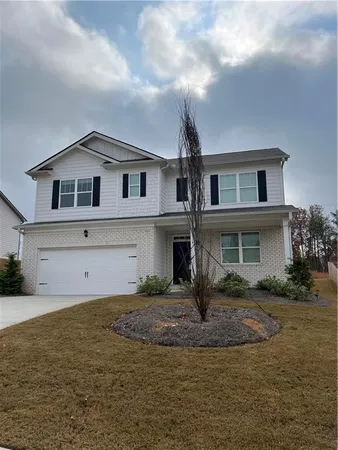 a front view of a house with garage