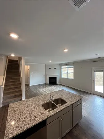 a kitchen with granite countertop a sink and a stove