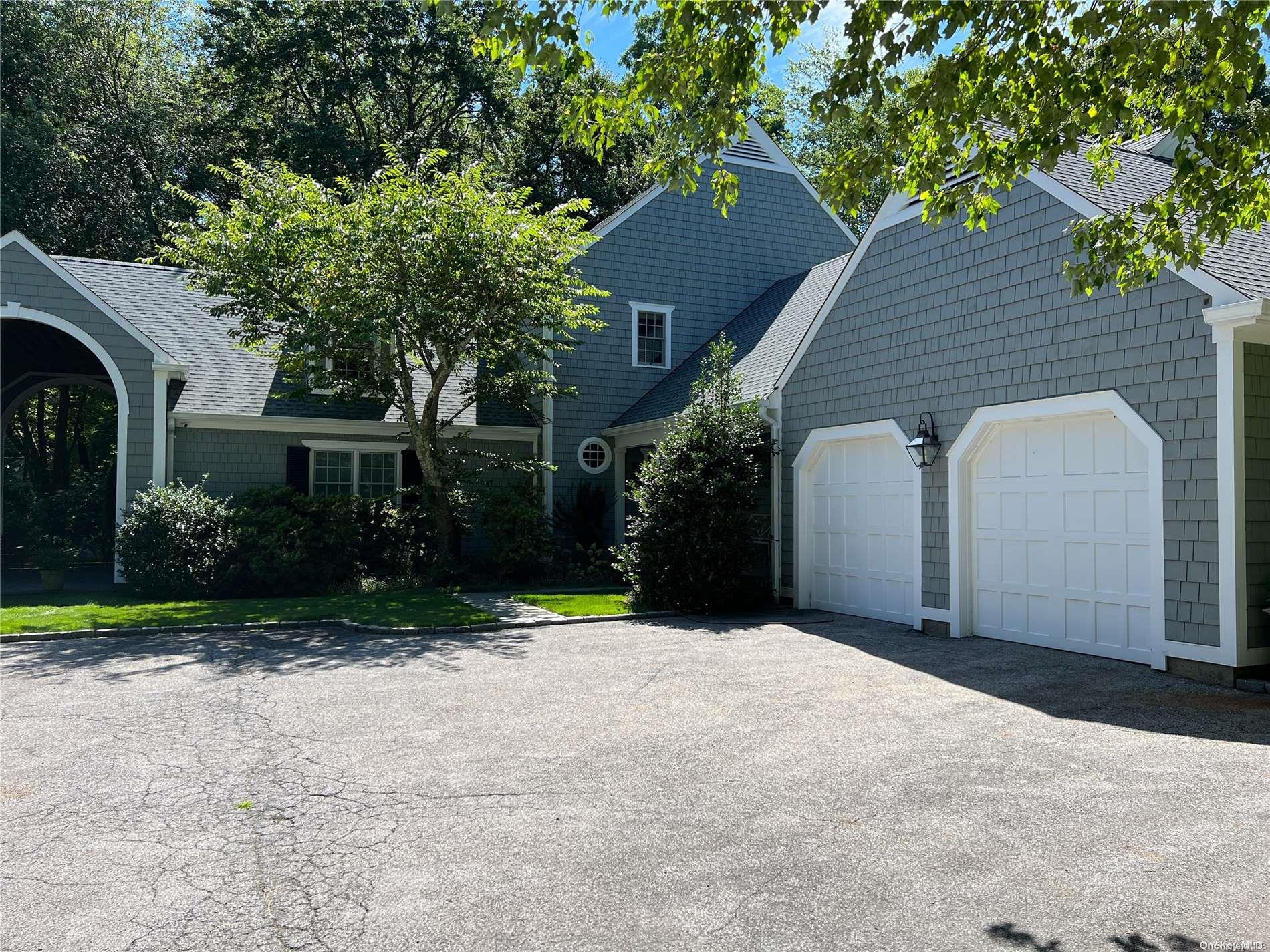 a backyard of a house with plants and trees