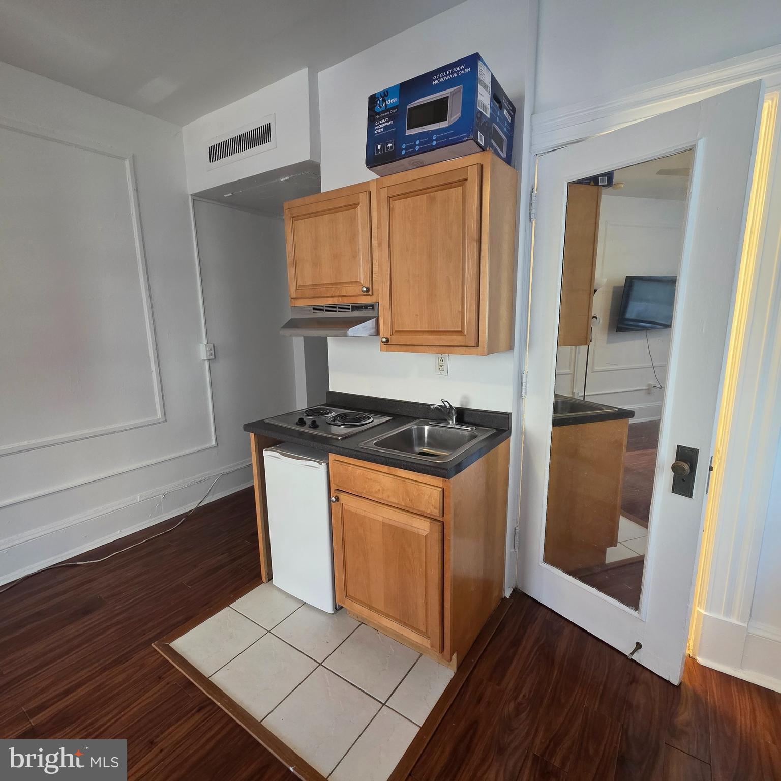 1324 Locust Street, Unit 412 Philadelphia, PA 19107 - Photo 11 of 20 a kitchen with stainless steel appliances granite countertop a stove a sink and a refrigerator