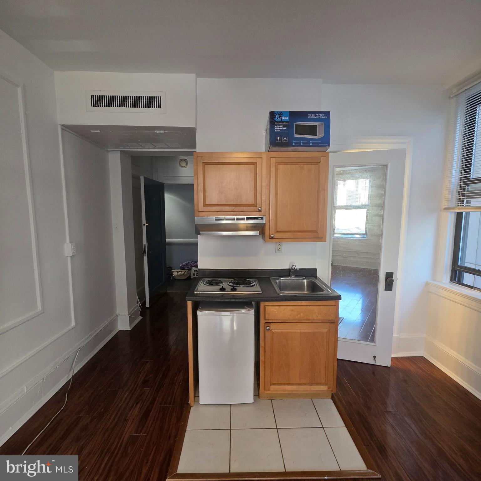 1324 Locust Street, Unit 412 Philadelphia, PA 19107 - Photo 12 of 20 a kitchen with granite countertop a stove and a refrigerator