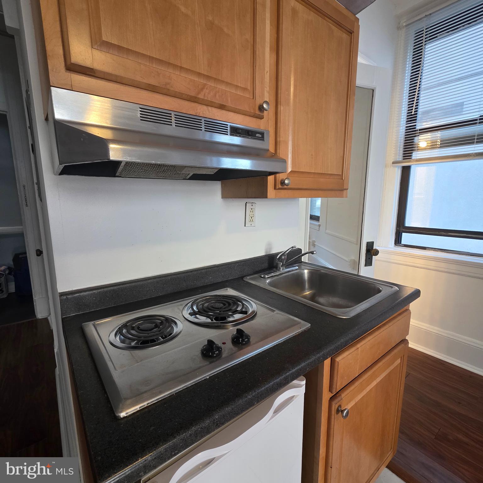 1324 Locust Street, Unit 412 Philadelphia, PA 19107 - Photo 13 of 20 a kitchen with a stove and a sink