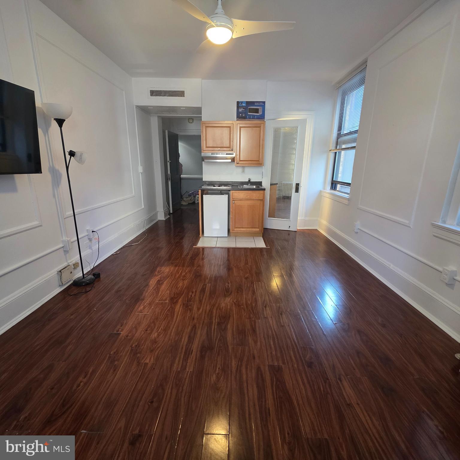 1324 Locust Street, Unit 412 Philadelphia, PA 19107 - Photo 3 of 20 a view of a kitchen with wooden floor electronic appliances and stairs