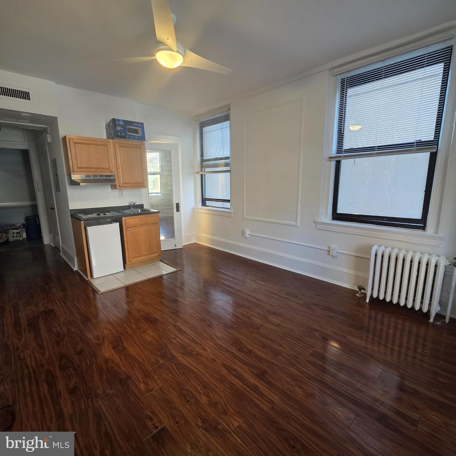 1324 Locust Street, Unit 412 Philadelphia, PA 19107 - Photo 5 of 20 a view of an empty room with wooden floor and a window
