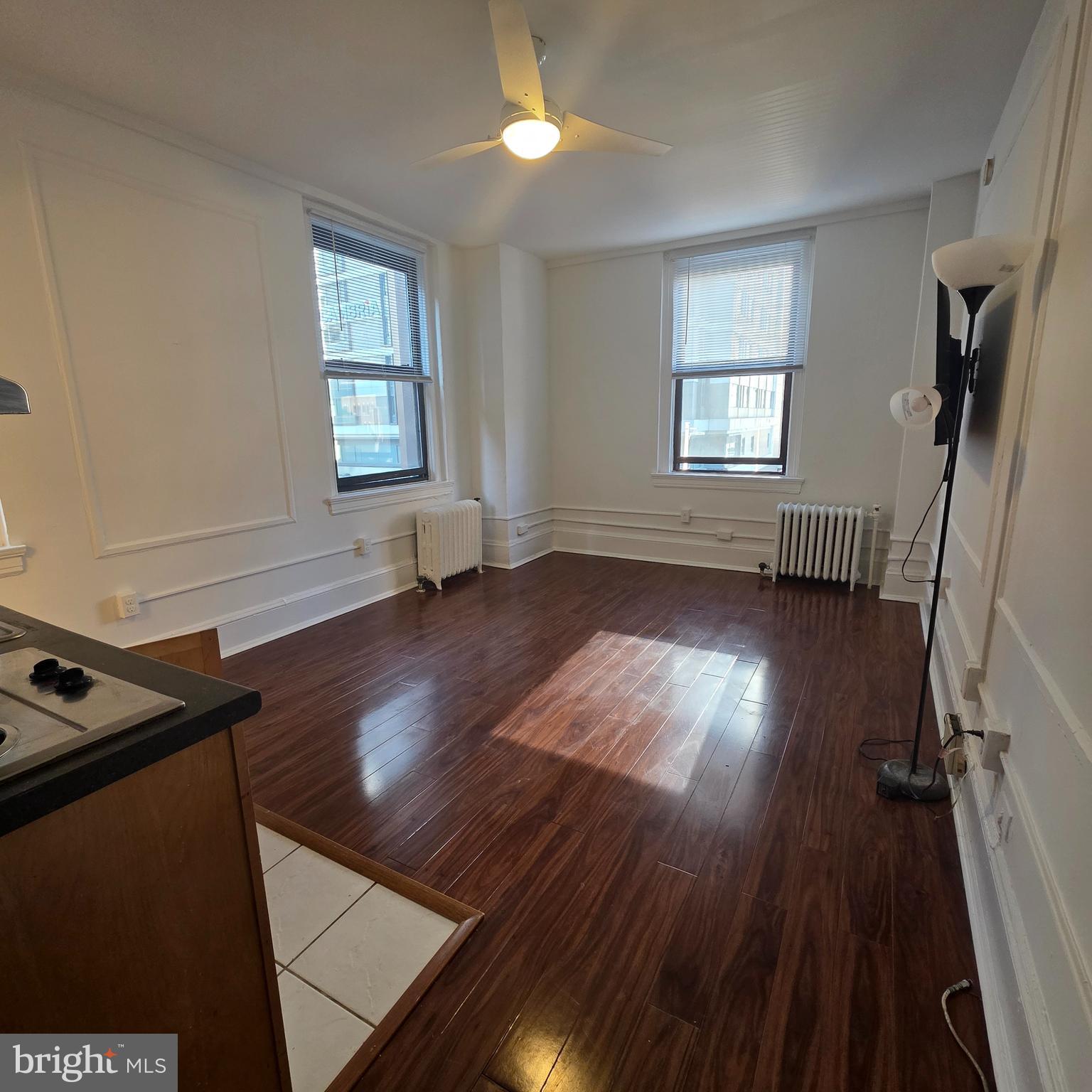 1324 Locust Street, Unit 412 Philadelphia, PA 19107 - Photo 6 of 20 wooden floor in an empty room with a window