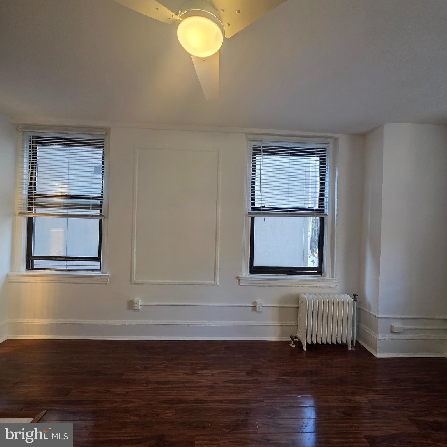 1324 Locust Street, Unit 412 Philadelphia, PA 19107 - Photo 10 of 20 a view of an empty room with wooden floor and a window