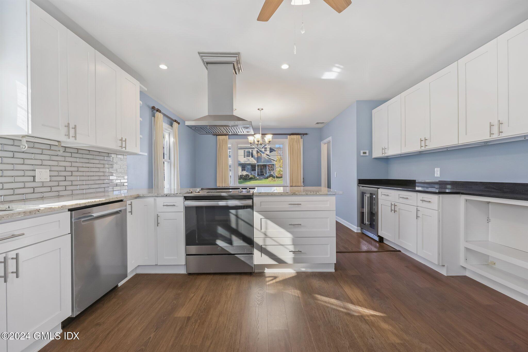 7 Hoover Road Riverside, CT 06878 - Photo 12 of 28 a kitchen with stainless steel appliances granite countertop a stove a sink and white cabinets