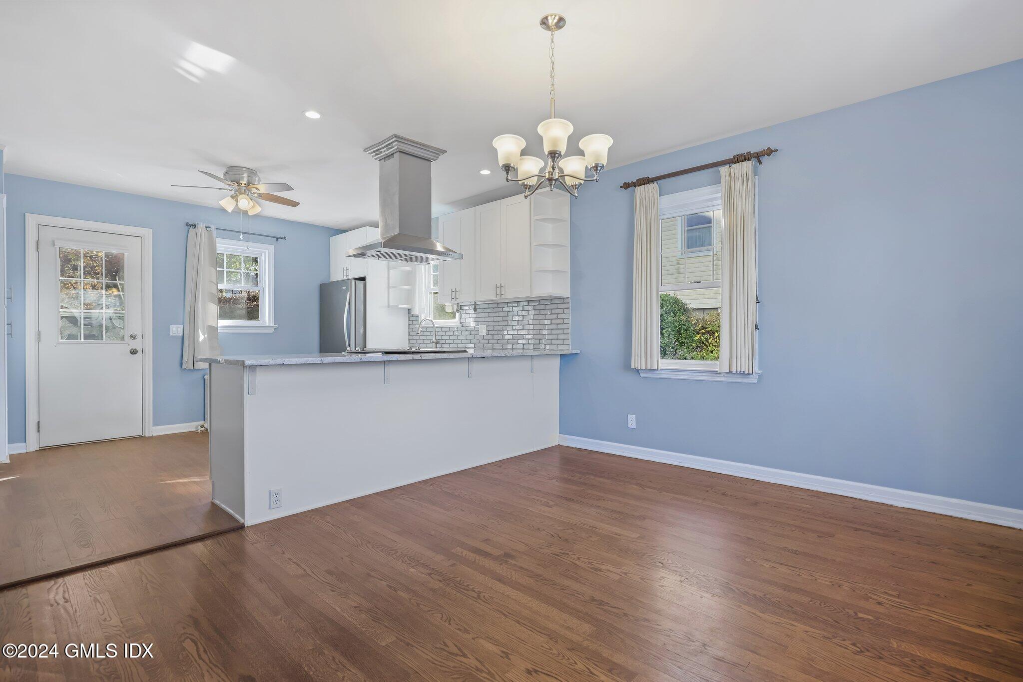 7 Hoover Road Riverside, CT 06878 - Photo 13 of 28 a view of a kitchen with granite countertop cabinets a chandelier and wooden floor