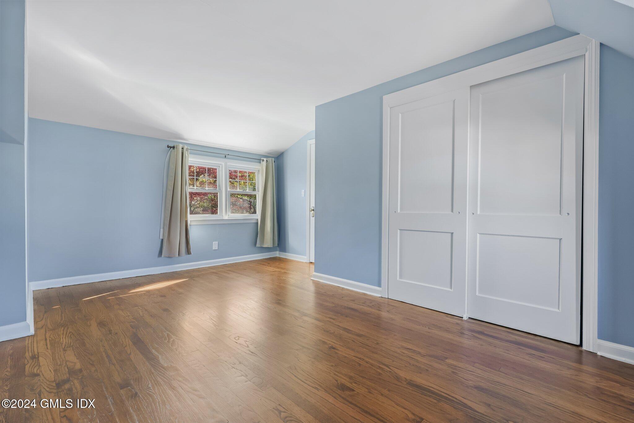 7 Hoover Road Riverside, CT 06878 - Photo 17 of 28 a view of an empty room with wooden floor and windows