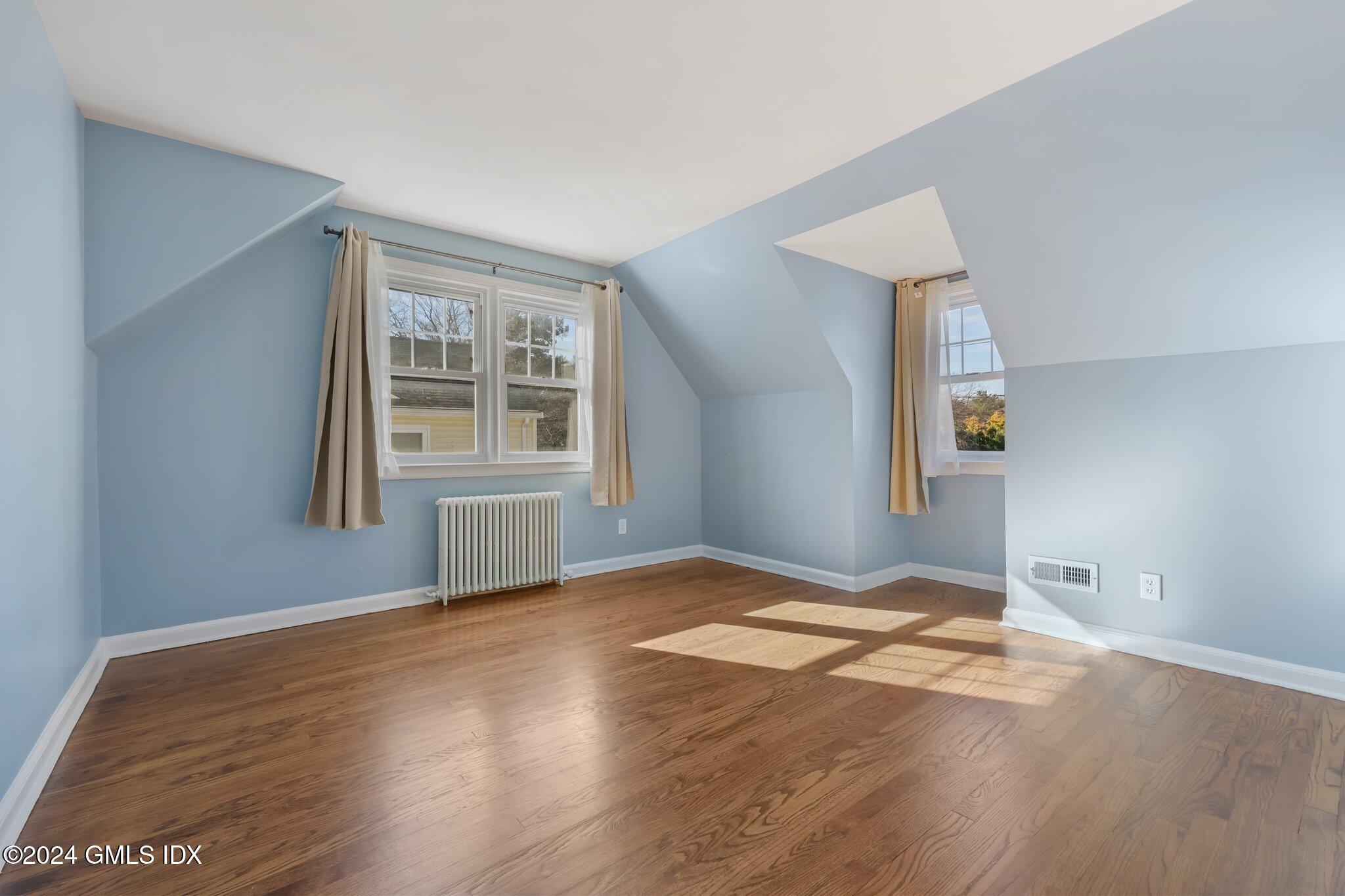7 Hoover Road Riverside, CT 06878 - Photo 19 of 28 a view of an empty room with wooden floor and windows
