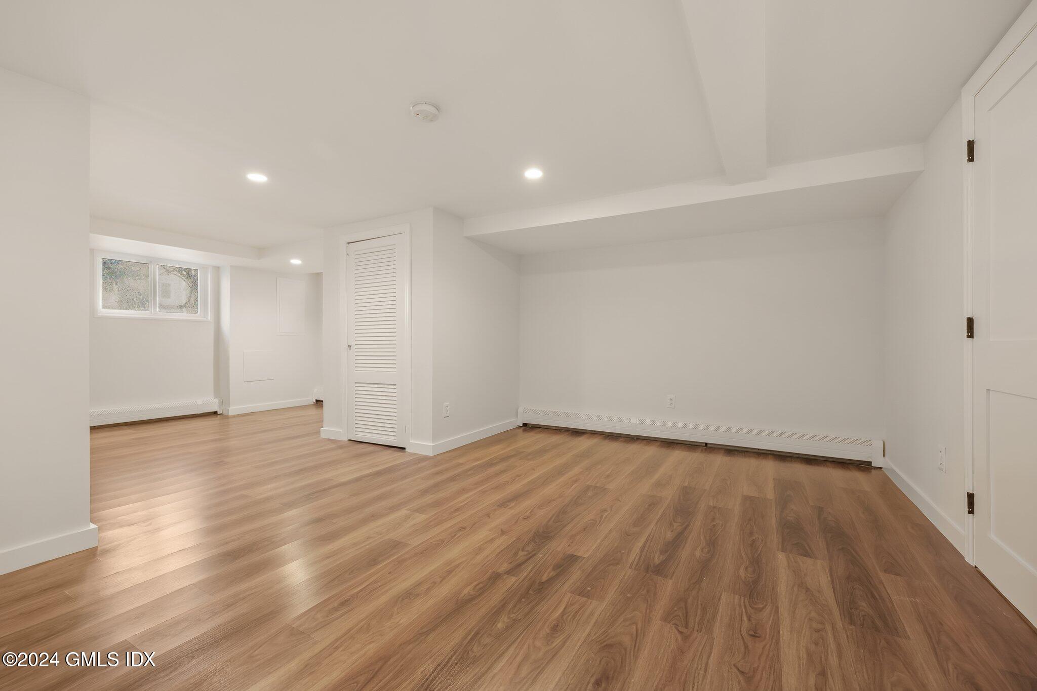 7 Hoover Road Riverside, CT 06878 - Photo 22 of 28 a view of an empty room with wooden floor and a window