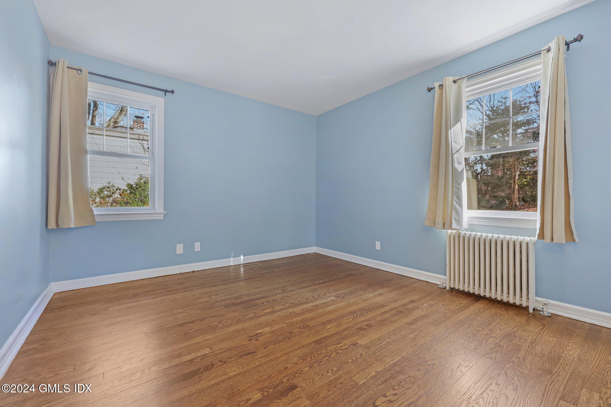 7 Hoover Road Riverside, CT 06878 - Photo 8 of 28 a view of an empty room with a window and wooden floor