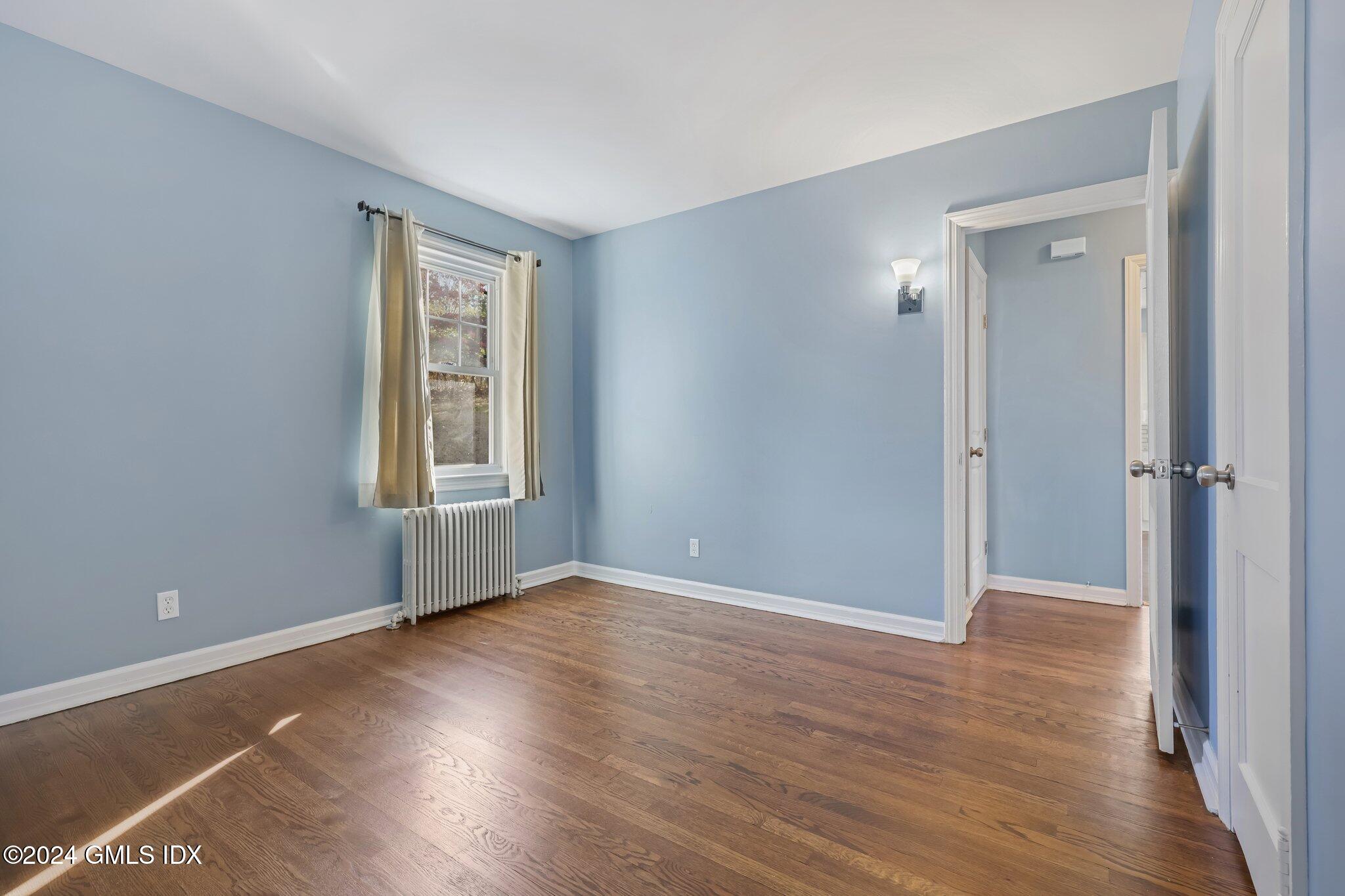 7 Hoover Road Riverside, CT 06878 - Photo 9 of 28 a view of an empty room with wooden floor and a window