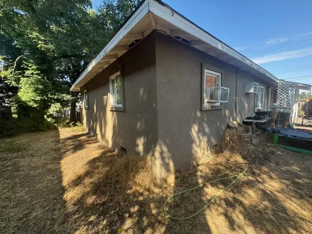 a backyard of a house with yard and outdoor seating