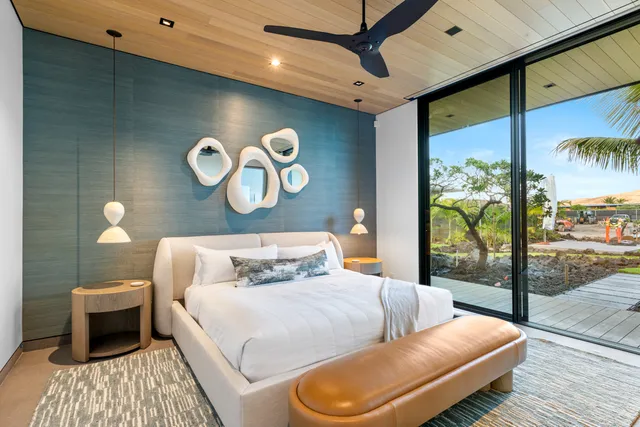 a bedroom with a bed and sliding glass door