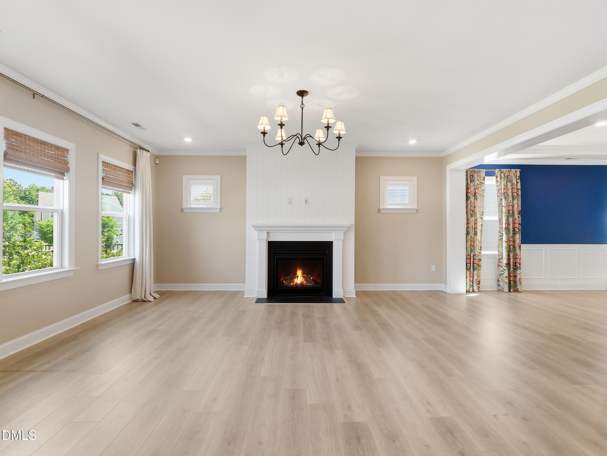 2709 Womble Ridge Drive New Hill, NC 27562 - Photo 12 of 60 a view of an empty room with a fireplace and a window
