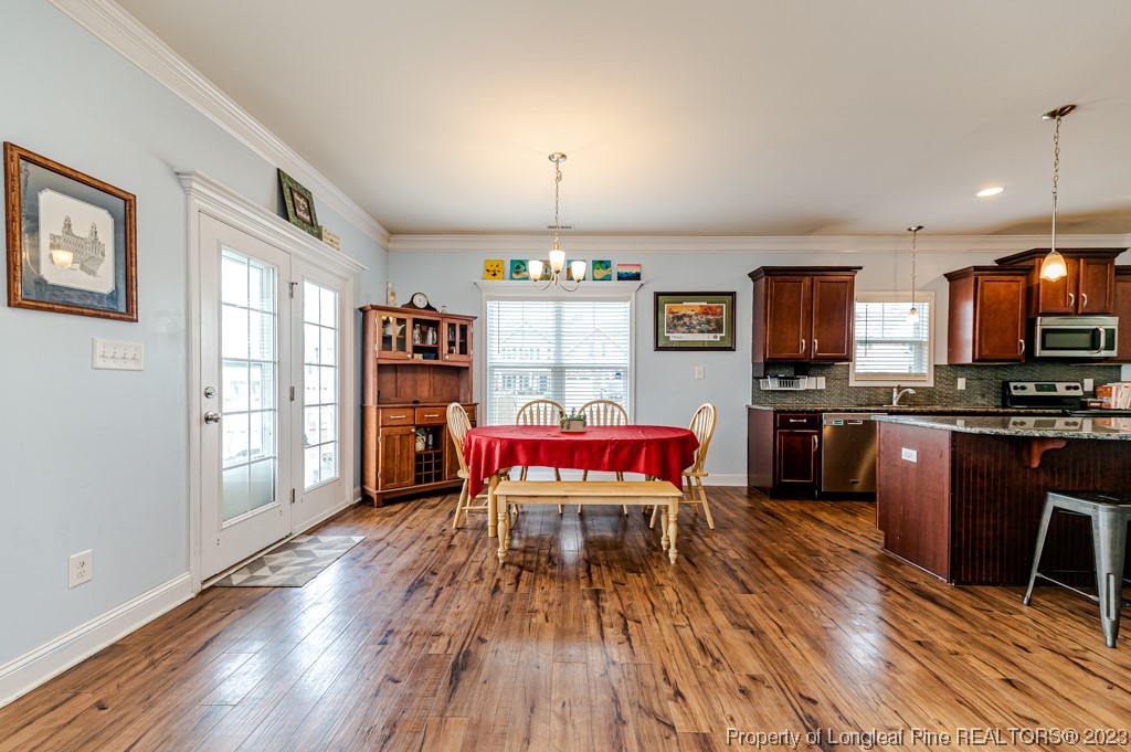 100 Lothian Ln. Cameron, NC 28326 - Photo 15 of 45 a living room with stainless steel appliances kitchen island granite countertop furniture wooden floor and a window