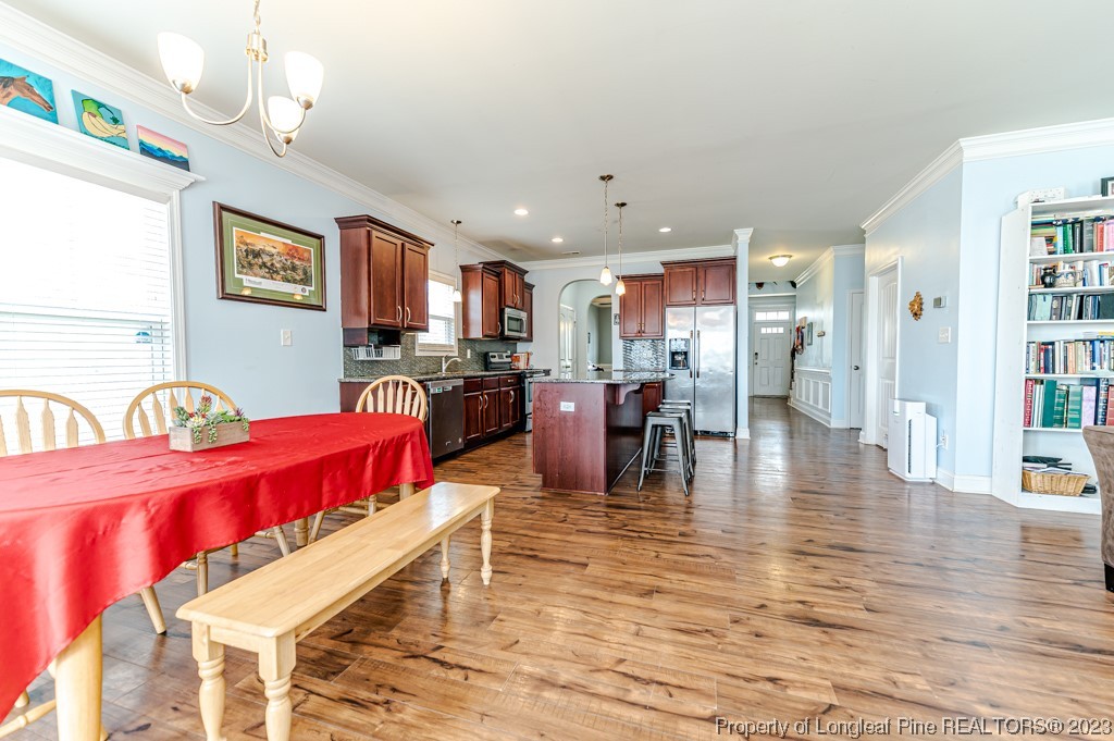 100 Lothian Ln. Cameron, NC 28326 - Photo 16 of 45 a living room with stainless steel appliances furniture and wooden floor
