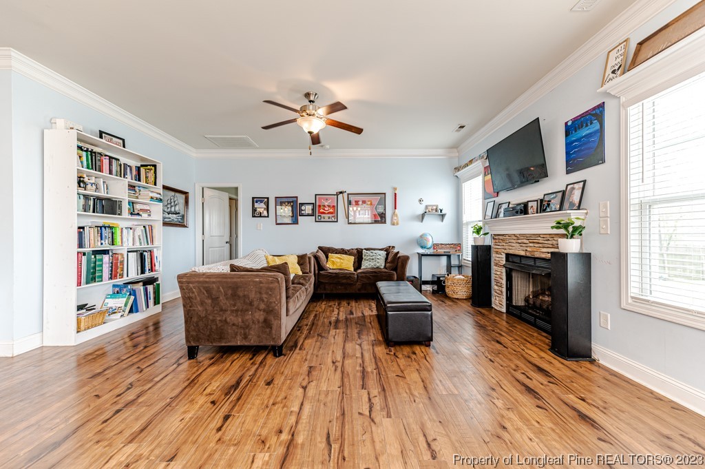 100 Lothian Ln. Cameron, NC 28326 - Photo 17 of 45 a living room with furniture fireplace and wooden floor