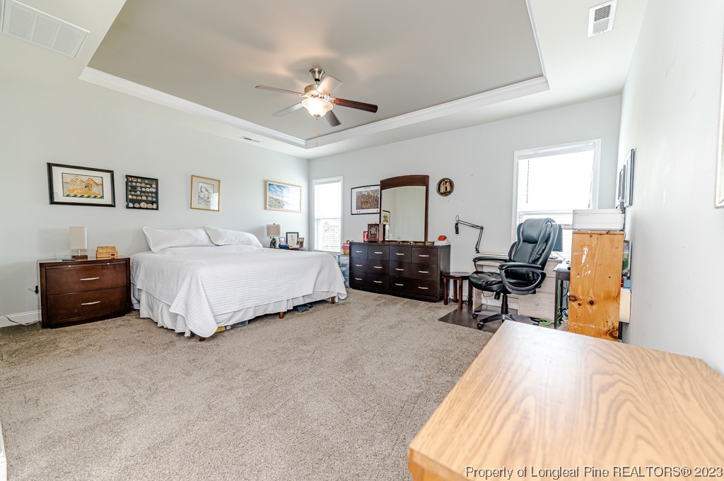 100 Lothian Ln. Cameron, NC 28326 - Photo 20 of 45 a bedroom with bed and a chandelier