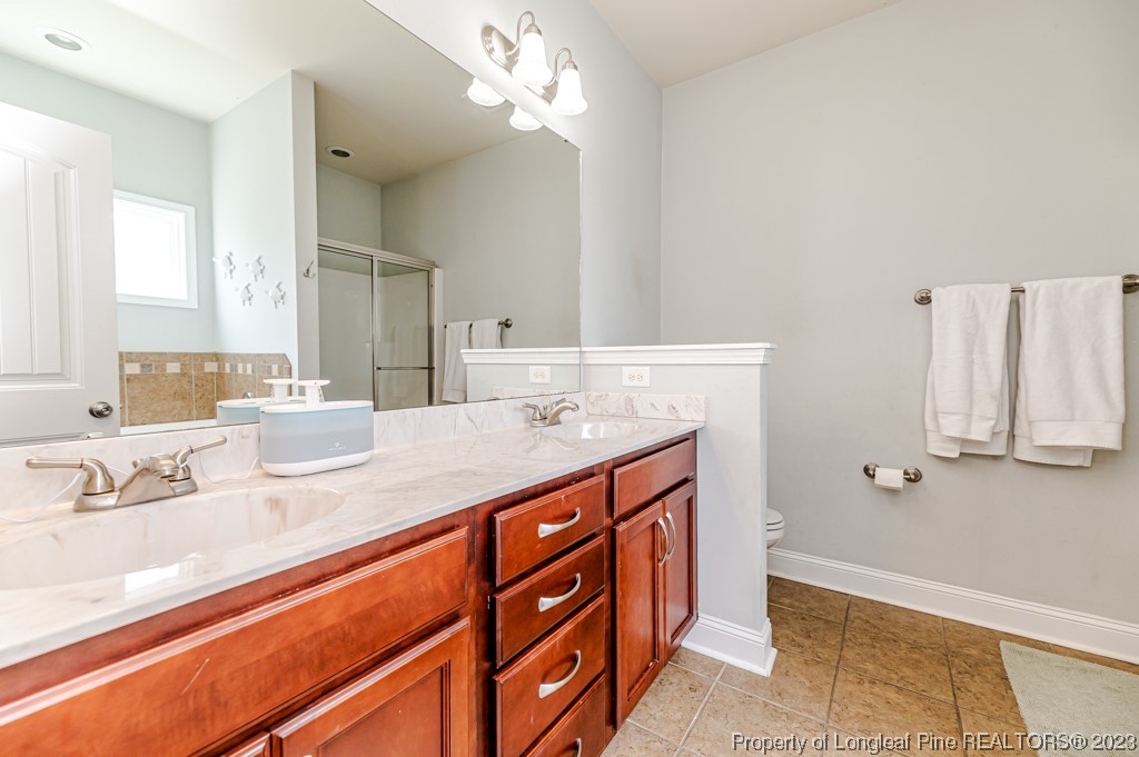 100 Lothian Ln. Cameron, NC 28326 - Photo 21 of 45 a bathroom with a sink double vanity and a mirror