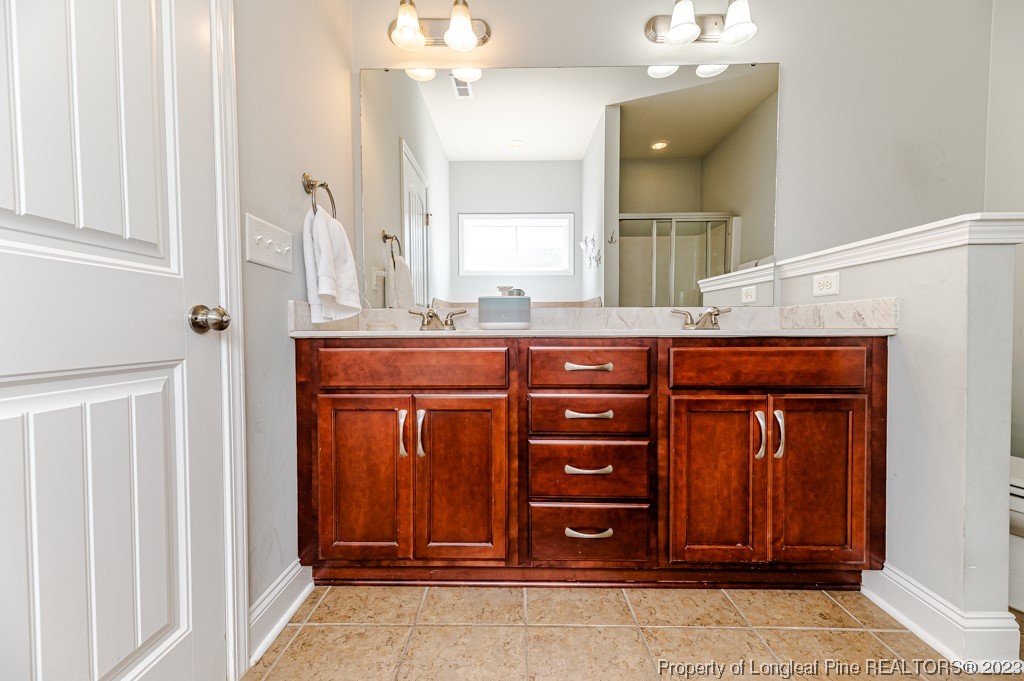100 Lothian Ln. Cameron, NC 28326 - Photo 22 of 45 a room with a dresser and a mirror
