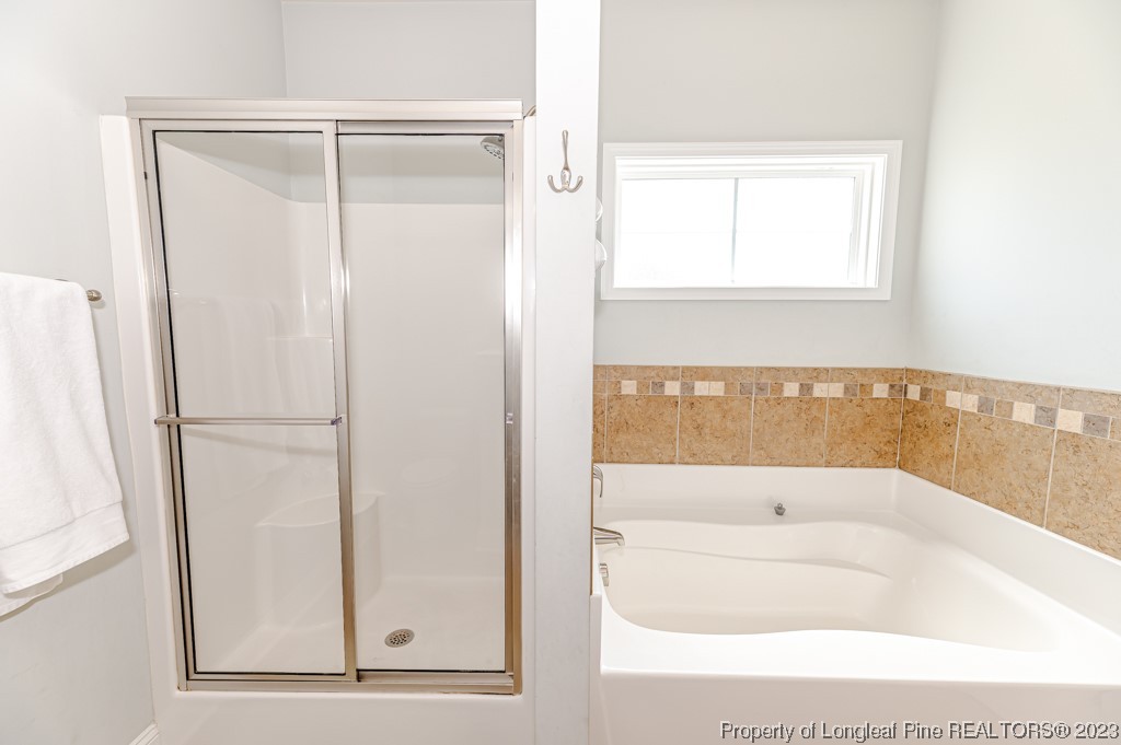 100 Lothian Ln. Cameron, NC 28326 - Photo 23 of 45 a bathroom with a bathtub and a shower