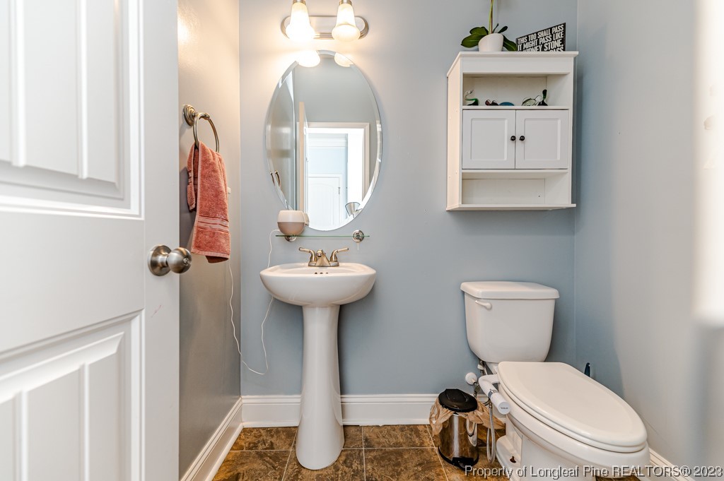 100 Lothian Ln. Cameron, NC 28326 - Photo 26 of 45 a bathroom with a toilet sink and mirror