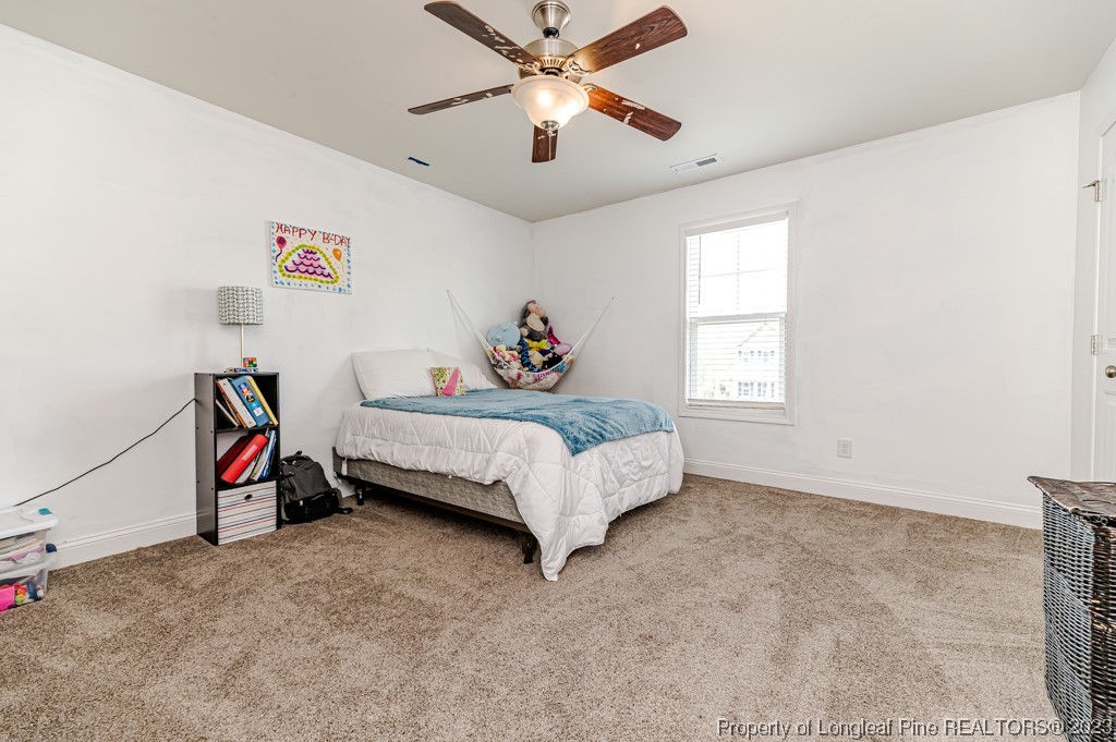 100 Lothian Ln. Cameron, NC 28326 - Photo 31 of 45 a bedroom with a bed and a chandelier