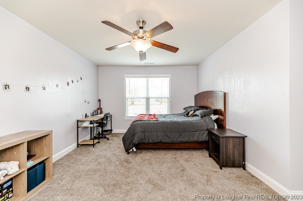100 Lothian Ln. Cameron, NC 28326 - Photo 34 of 45 a bedroom with a bed and a chandelier