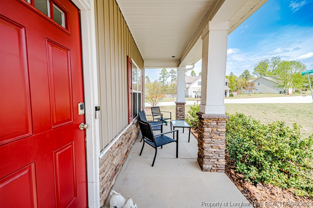 100 Lothian Ln. Cameron, NC 28326 - Photo 4 of 45 a balcony with furniture and a potted plant